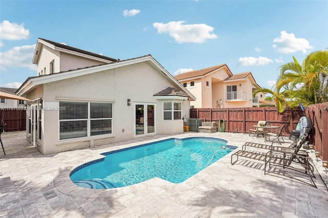 5081 SW 154th Pl, Miami, FL 33185 - view of swimming pool featuring french doors, a patio, fence, and cooling unit