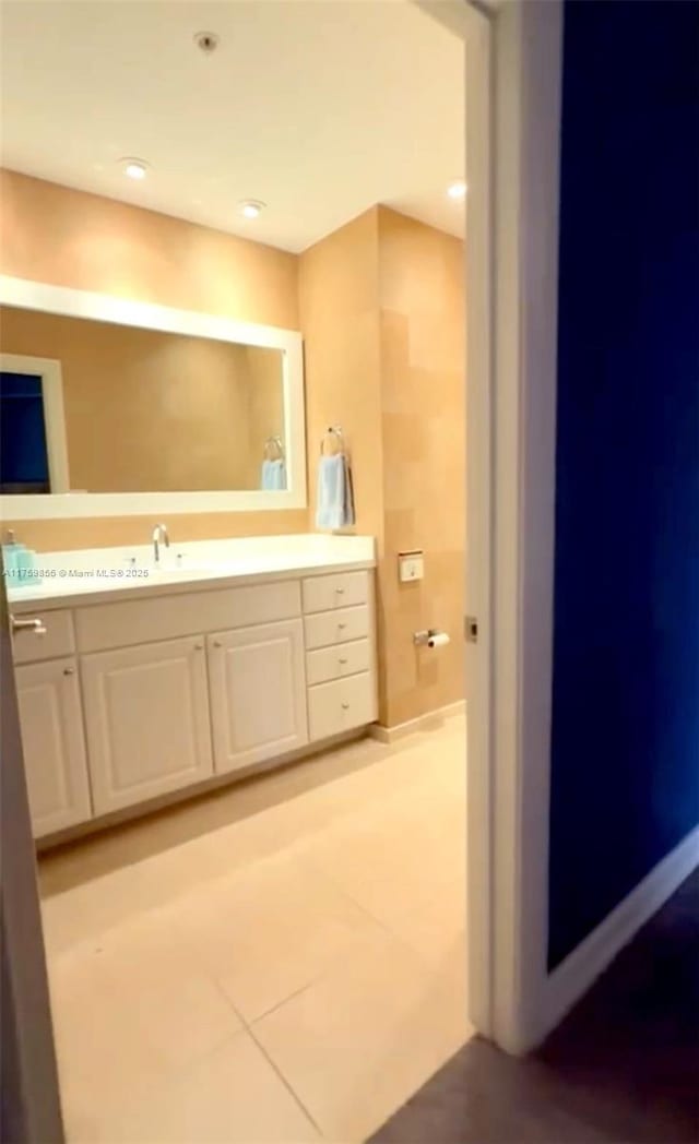 bathroom with tile patterned flooring and vanity