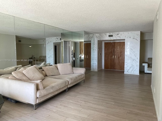 20281 E Country Club Dr Unit 810, Aventura, FL 33180 - living room with visible vents, a textured ceiling, and light wood-style flooring