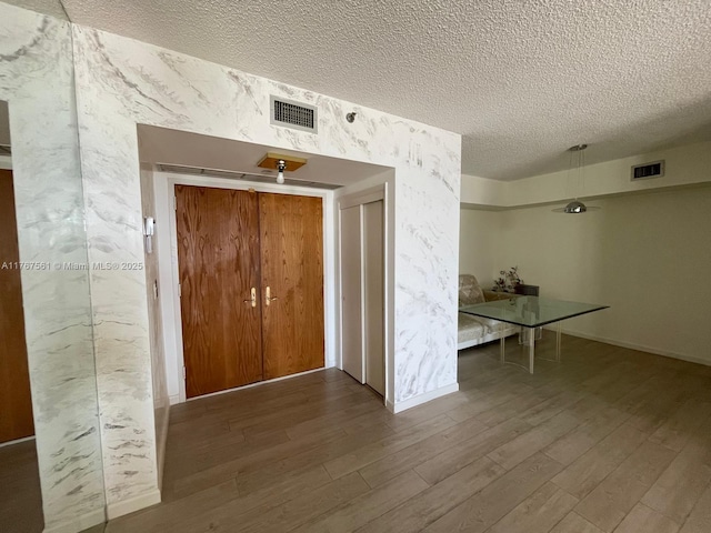 20281 E Country Club Dr Unit 810, Aventura, FL 33180 - corridor featuring wood finished floors, a textured ceiling, and visible vents