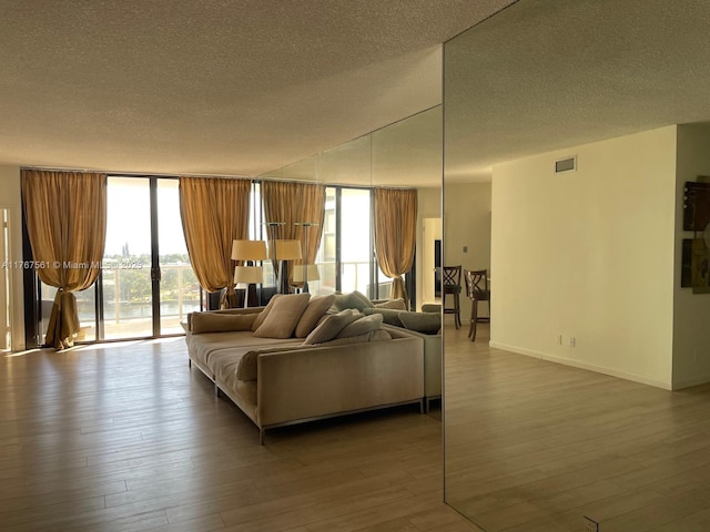 20281 E Country Club Dr Unit 810, Aventura, FL 33180 - living area featuring visible vents, plenty of natural light, a wall of windows, and wood finished floors