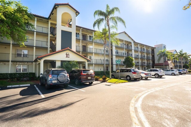 view of building exterior with uncovered parking