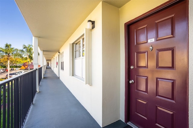 doorway to property with stucco siding and a balcony