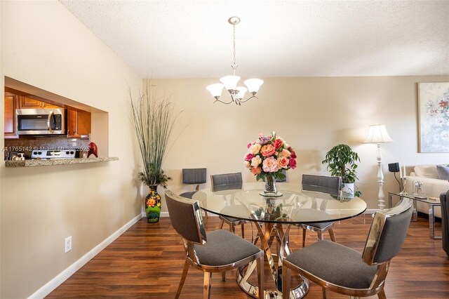 12900 SW 13th St Unit 211E, Pembroke Pines, FL 33027 - dining room featuring wood finished floors, a textured ceiling, a chandelier, and baseboards