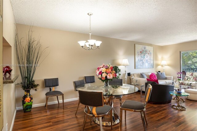 12900 SW 13th St Unit 211E, Pembroke Pines, FL 33027 - dining room featuring a chandelier, dark wood-style floors, and baseboards