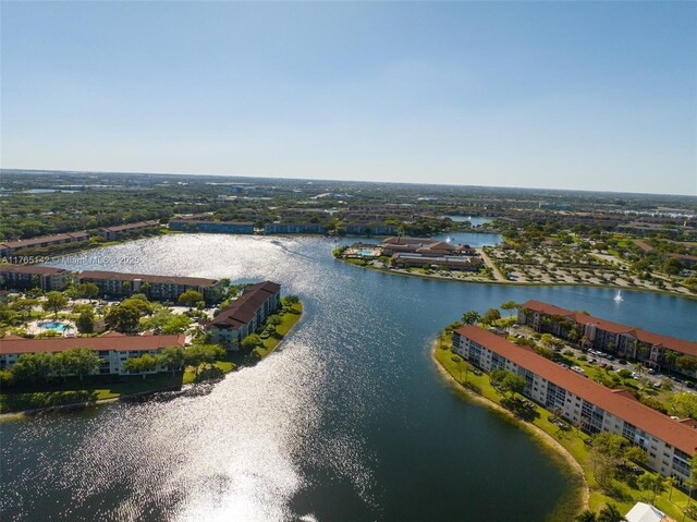 12900 SW 13th St Unit 211E, Pembroke Pines, FL 33027 - washroom featuring stacked washing machine and dryer