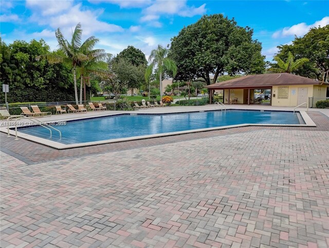12900 SW 13th St Unit 211E, Pembroke Pines, FL 33027 - community pool with a patio area and fence