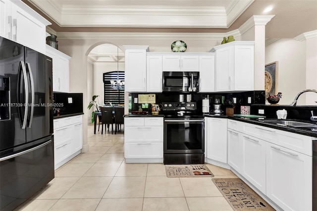 32006 SW 206th Ave, Homestead, FL 33030 - kitchen with black appliances, ornamental molding, white cabinetry, light tile patterned floors, and dark countertops