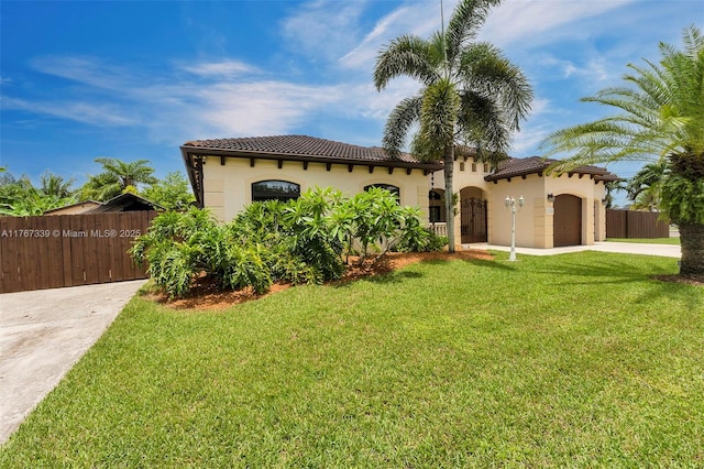 32006 SW 206th Ave, Homestead, FL 33030 - mediterranean / spanish house with driveway, a tile roof, a garage, and stucco siding