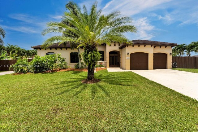 32006 SW 206th Ave, Homestead, FL 33030 - mediterranean / spanish-style house featuring an attached garage, stucco siding, driveway, and a tiled roof