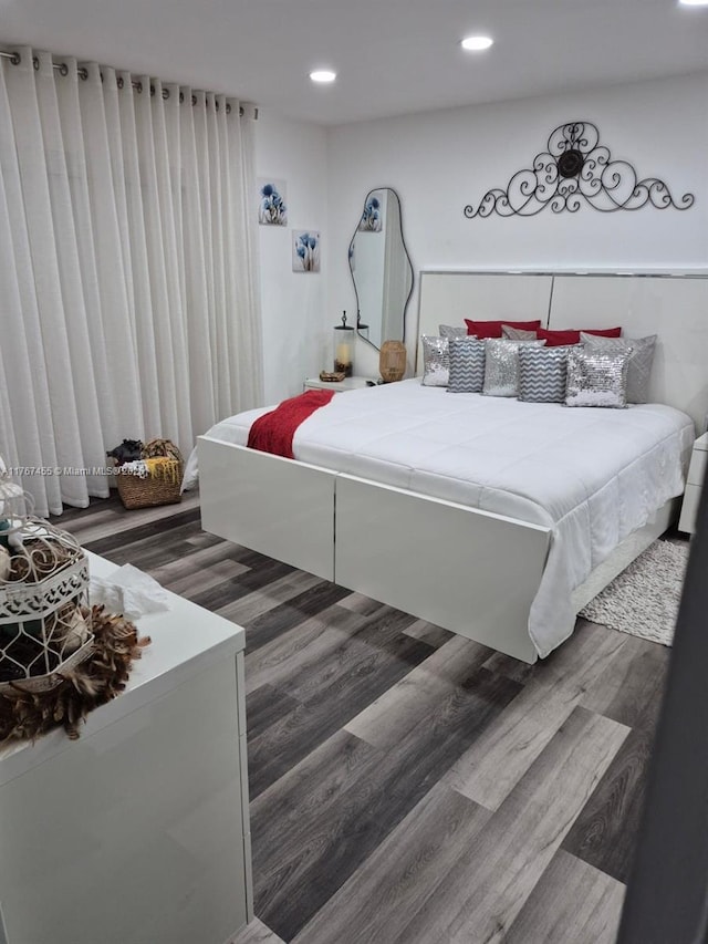 bedroom with recessed lighting and dark wood-type flooring