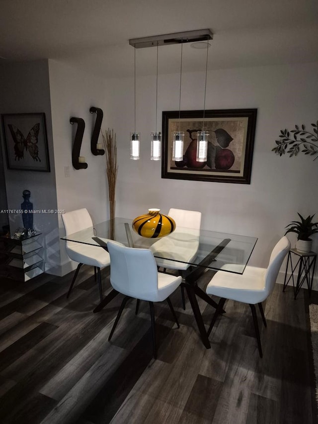 dining room featuring wood finished floors and baseboards