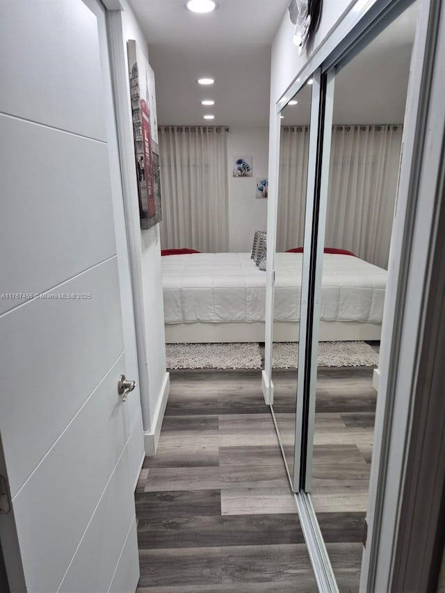 hallway with recessed lighting and wood finished floors