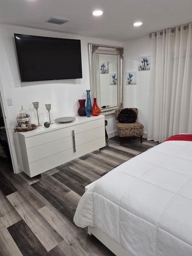 bedroom featuring recessed lighting, wood finished floors, and visible vents