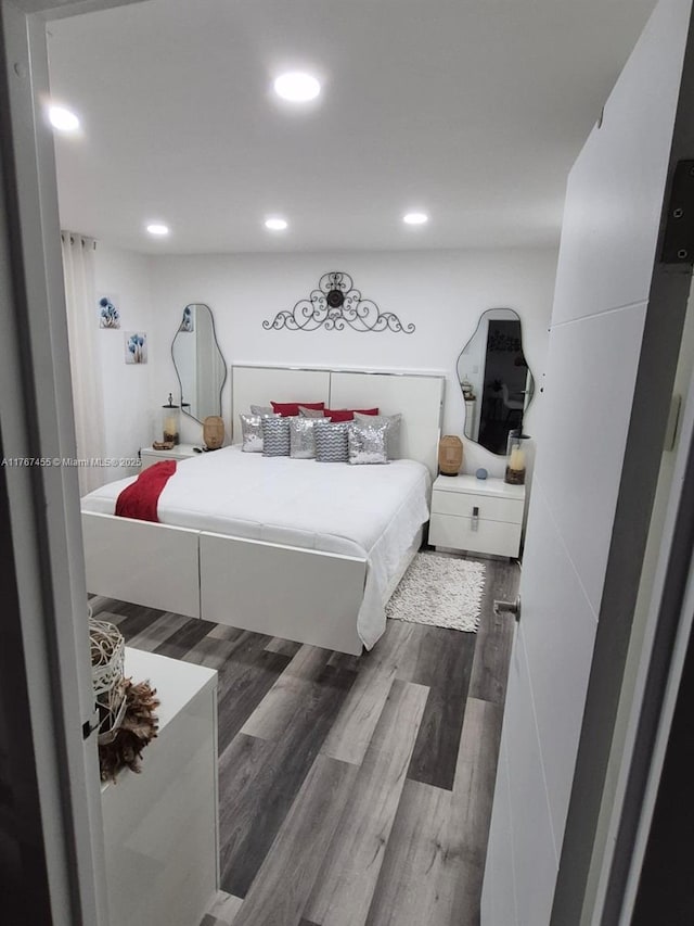 bedroom featuring recessed lighting and wood finished floors