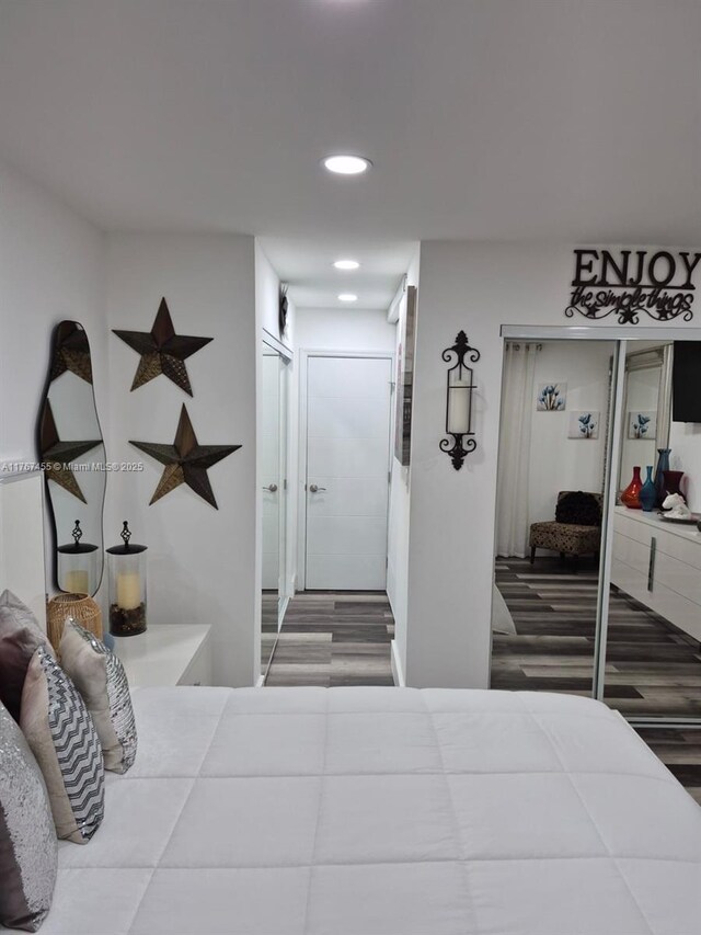 bedroom with recessed lighting and wood finished floors