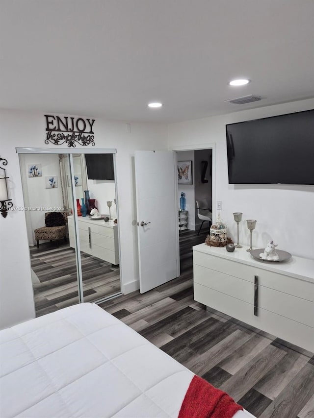 bedroom with visible vents, recessed lighting, and wood finished floors