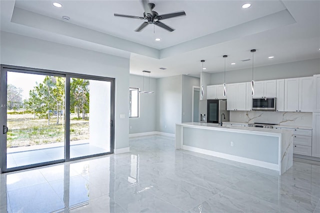1254 S Ellipse St E, Lehigh Acres, FL 33974 - kitchen with a sink, a raised ceiling, stainless steel appliances, and recessed lighting