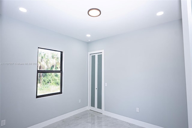 1254 S Ellipse St E, Lehigh Acres, FL 33974 - empty room with recessed lighting, baseboards, and marble finish floor