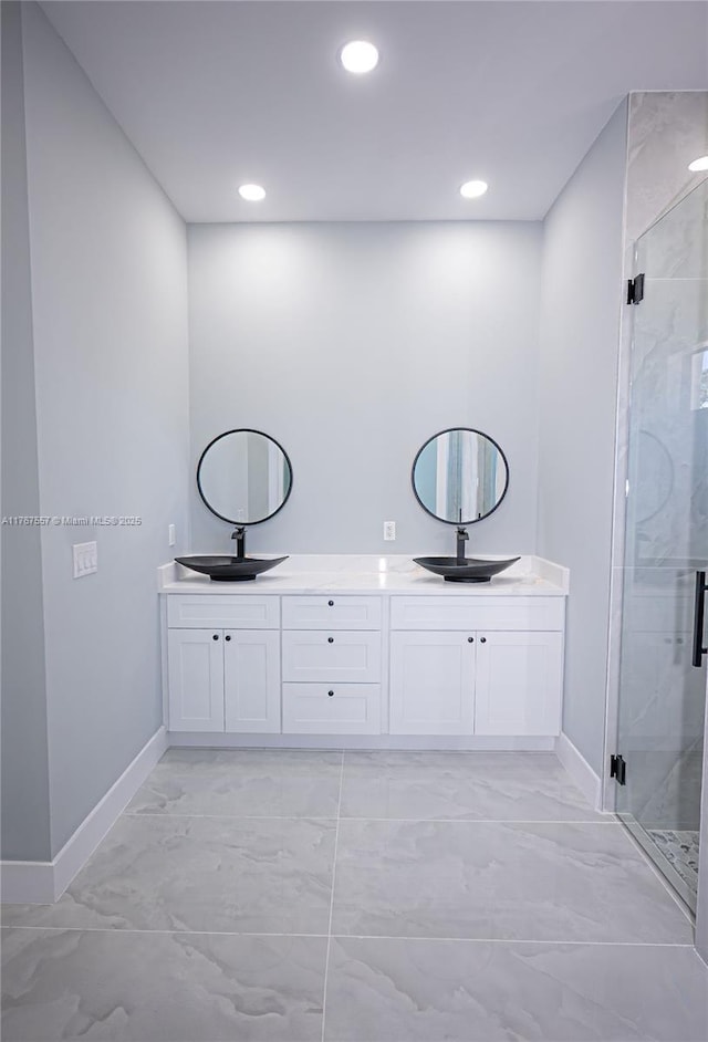 1254 S Ellipse St E, Lehigh Acres, FL 33974 - full bathroom with double vanity, baseboards, a shower stall, and marble finish floor