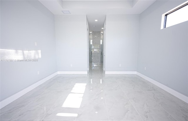 1254 S Ellipse St E, Lehigh Acres, FL 33974 - spare room with baseboards, a tray ceiling, and marble finish floor