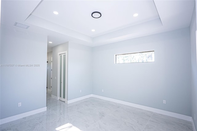 1254 S Ellipse St E, Lehigh Acres, FL 33974 - spare room with visible vents, marble finish floor, baseboards, recessed lighting, and a raised ceiling