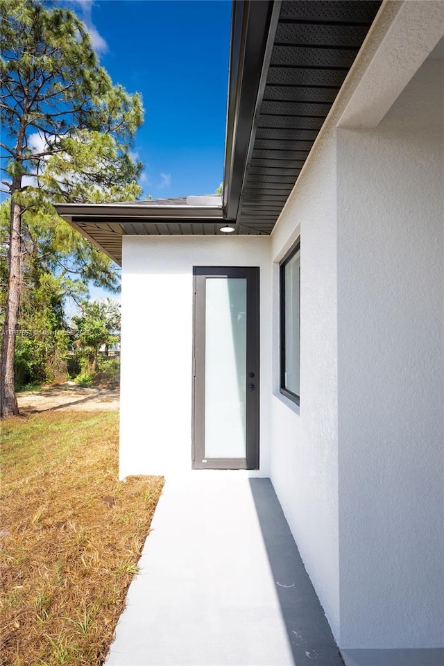 1254 S Ellipse St E, Lehigh Acres, FL 33974 - property entrance with stucco siding and a yard