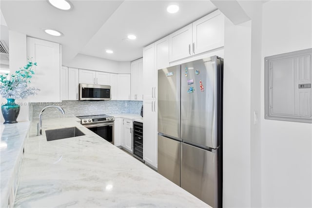 2501 S Ocean Dr Unit 536, Hollywood, FL 33019 - kitchen with appliances with stainless steel finishes, beverage cooler, light stone counters, electric panel, and recessed lighting
