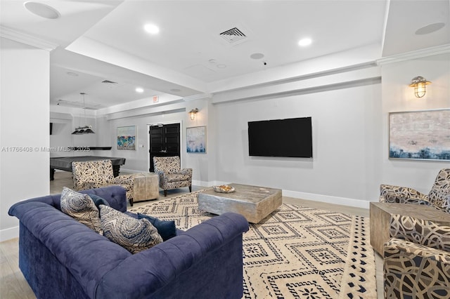 living area featuring visible vents, baseboards, and wood finished floors
