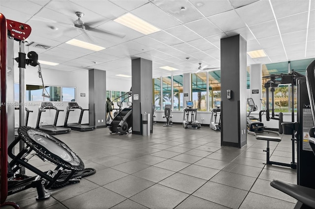 gym featuring a ceiling fan, visible vents, and a drop ceiling
