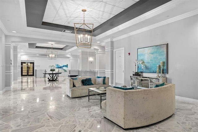 living area featuring a tray ceiling, baseboards, an inviting chandelier, and crown molding