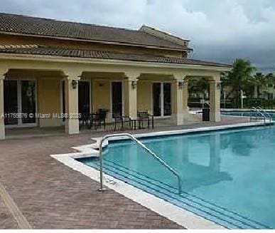 community pool with a patio area