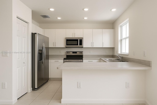 2737 SE 17th St, Homestead, FL 33035 - kitchen featuring appliances with stainless steel finishes, a peninsula, a sink, light countertops, and recessed lighting