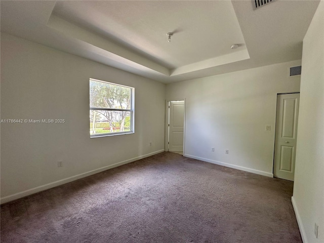 2737 SE 17th St, Homestead, FL 33035 - carpeted spare room with a tray ceiling and baseboards