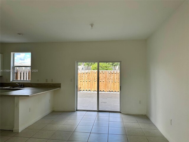 2737 SE 17th St, Homestead, FL 33035 - unfurnished dining area featuring light tile patterned flooring, baseboards, and a sink