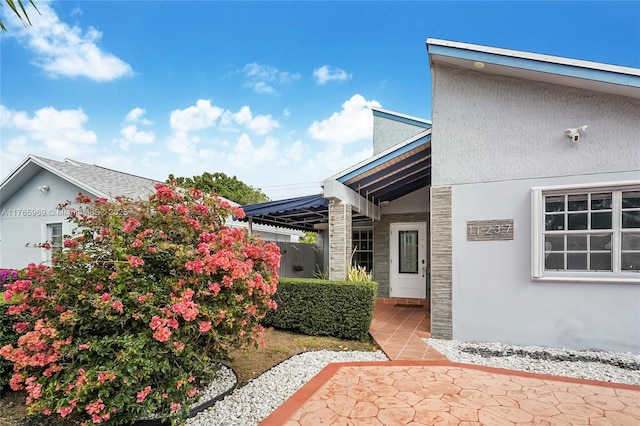 exterior space featuring a patio area and stucco siding