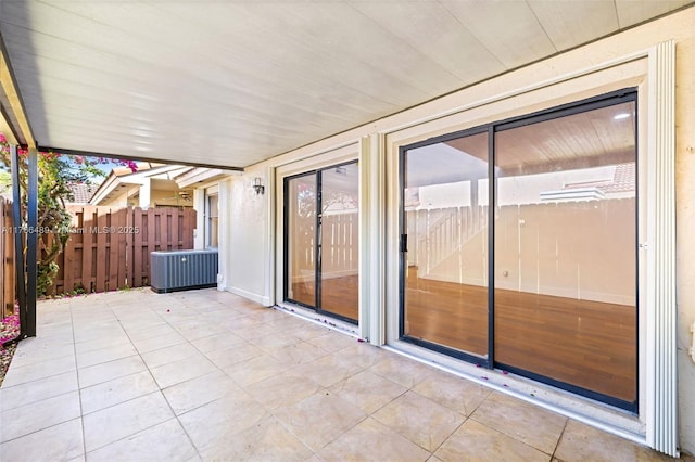 view of patio / terrace with central air condition unit and fence
