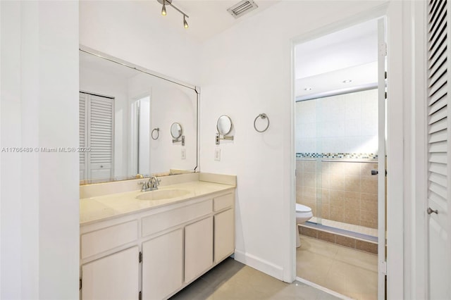 bathroom featuring visible vents, toilet, a stall shower, a closet, and vanity