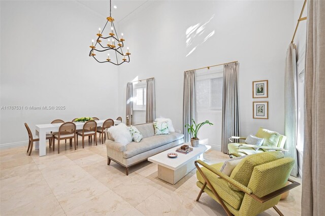 3120 Virginia St Unit 3120, Miami, FL 33133 - living area featuring a towering ceiling, a chandelier, and light marble finish floors