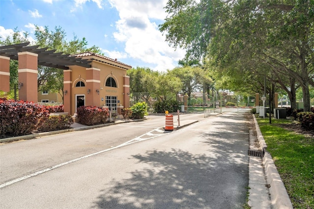 983 SW 143rd Ave Unit 1403, Pembroke Pines, FL 33027 - view of asphalt street featuring curbs and a gated entry
