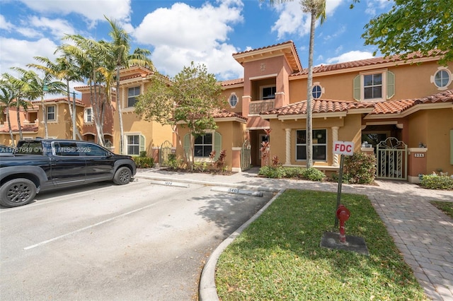 983 SW 143rd Ave Unit 1403, Pembroke Pines, FL 33027 - view of front of house featuring stucco siding, uncovered parking, and a tile roof