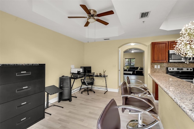 983 SW 143rd Ave Unit 1403, Pembroke Pines, FL 33027 - kitchen featuring appliances with stainless steel finishes, a raised ceiling, a ceiling fan, arched walkways, and light wood-type flooring