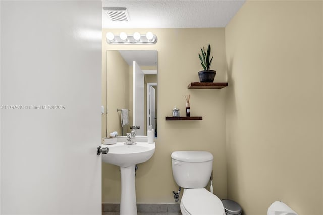 983 SW 143rd Ave Unit 1403, Pembroke Pines, FL 33027 - half bathroom featuring toilet and tile patterned floors