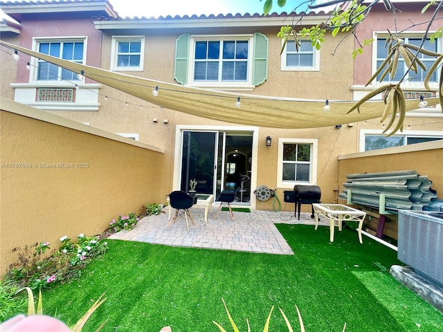 983 SW 143rd Ave Unit 1403, Pembroke Pines, FL 33027 - back of house with central AC unit, stucco siding, a patio, and a yard