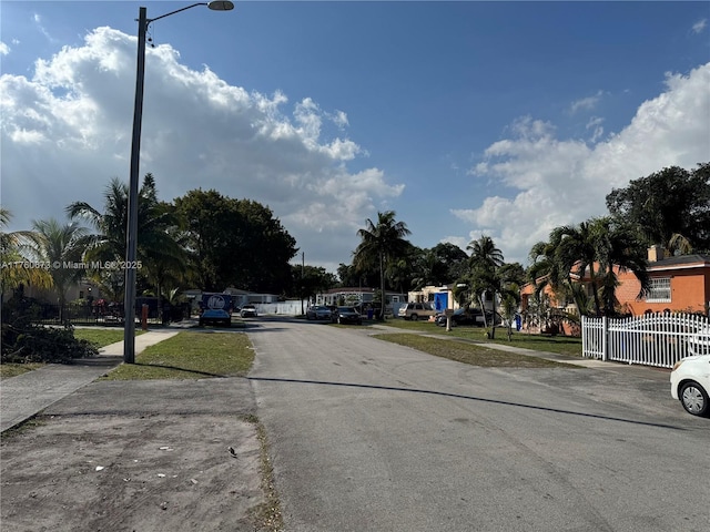 1077 NE 157th Ter, North Miami Beach, FL 33162 - view of street featuring sidewalks and street lighting