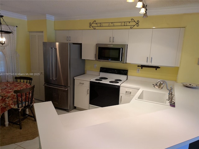 2334 S Cypress Bend Dr Unit 602, Pompano Beach, FL 33069 - kitchen featuring stainless steel appliances, a sink, light countertops, white cabinetry, and light tile patterned floors