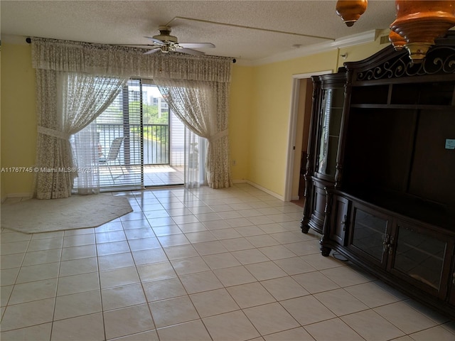 2334 S Cypress Bend Dr Unit 602, Pompano Beach, FL 33069 - unfurnished living room with a textured ceiling, ceiling fan, light tile patterned flooring, baseboards, and crown molding