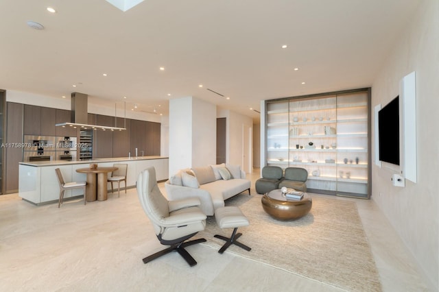 living room with bar and recessed lighting