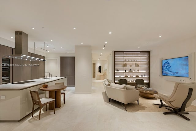 living room featuring baseboards and recessed lighting