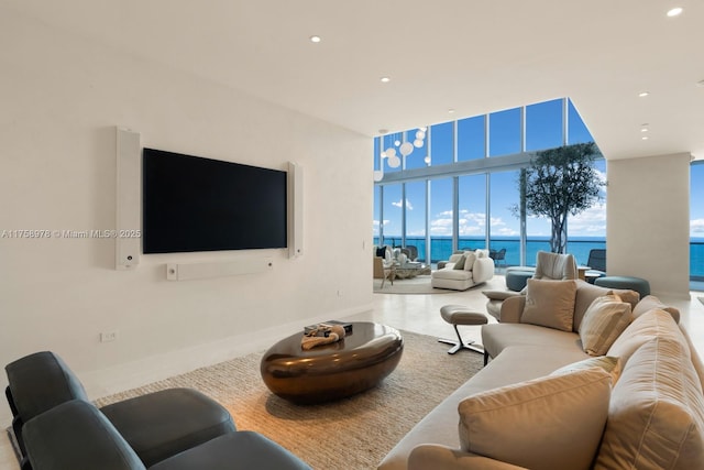 living room featuring a wall of windows, baseboards, and recessed lighting